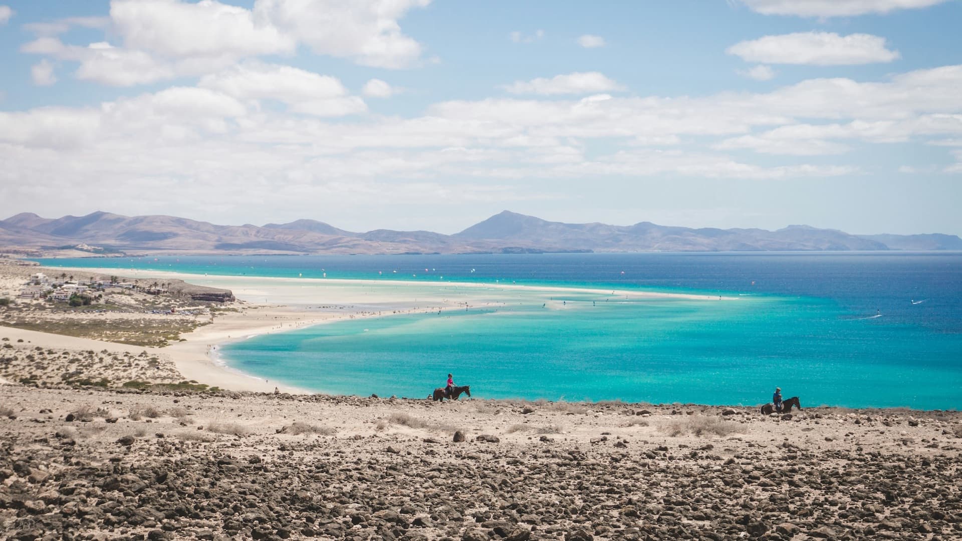 The turquoise Sotavento lagoon and sandbar seen from the dunes, sails dotting the water