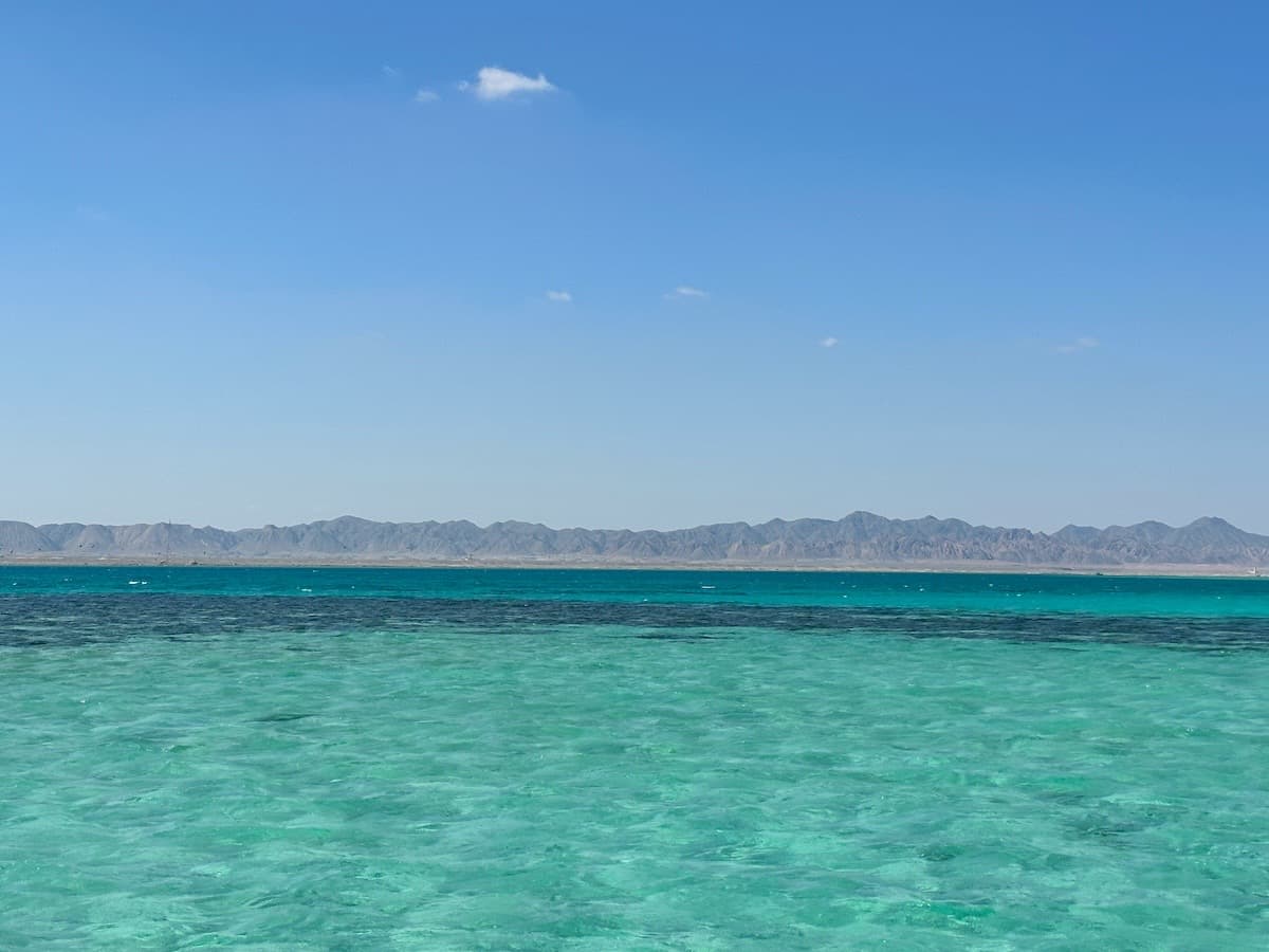 The shallow turquoise Red Sea lagoon at El Gouna with the desert mountains of Egypt behind