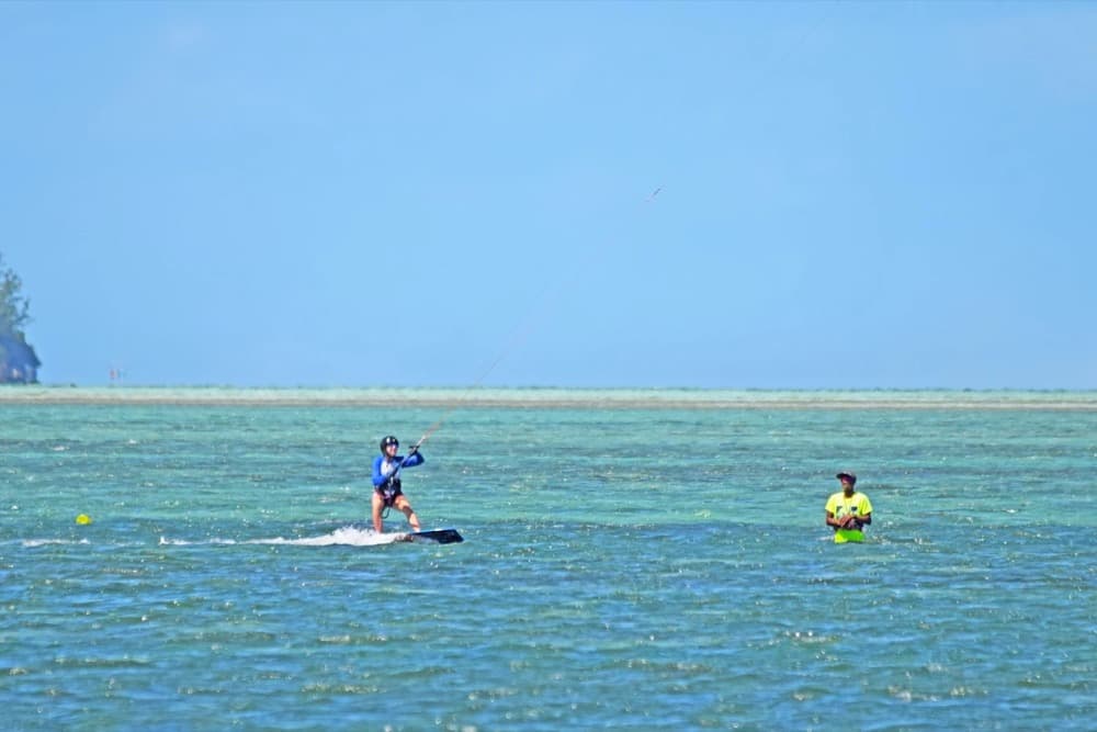 Kitesurfers rigging on the beach at Le Morne with the basalt mountain behind