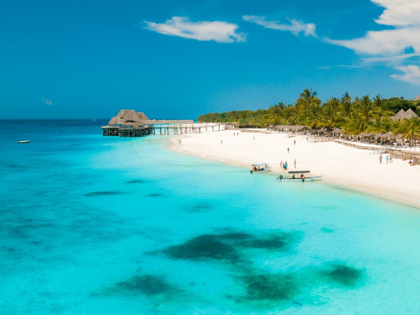 Kitesurfers riding over the shallow turquoise lagoon at Paje on Zanzibar's south-east coast
